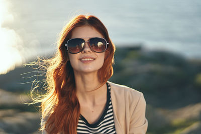 Portrait of smiling young woman wearing sunglasses