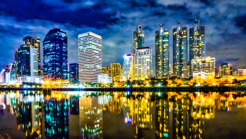 Reflection of illuminated buildings in city at night