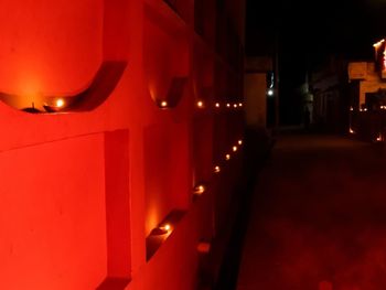 Light bulbs hanging on railing at night