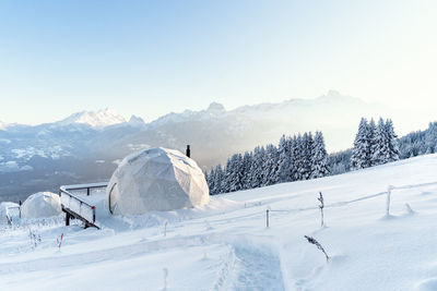 Winter igloo eco hotel in swiss mountauns covered by white snow with amazing view. luxury pods 