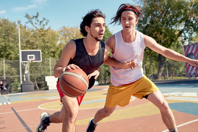 Young men playing basketball