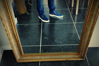 Low section of people standing on tiled floor