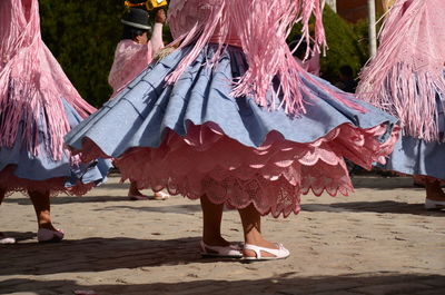 Low section of women dancing on street during traditional festival