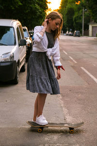 Full length of woman standing on street in city