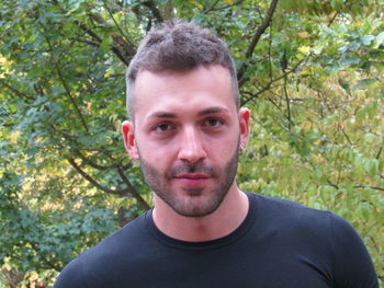 Portrait of young man against plants