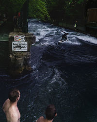 High angle view of shirtless man swimming in water