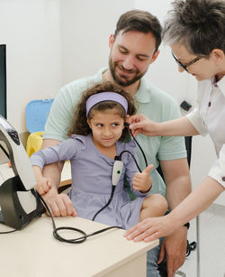 Female doctor examining patient at clinic