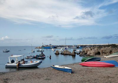 Boats moored on sea against sky