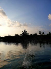 Scenic view of lake against sky at sunset