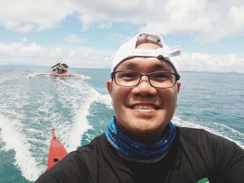 Portrait of smiling man by sea