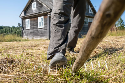 Low section of man standing on field