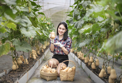 Portrait of smiling young woman sitting outdoors