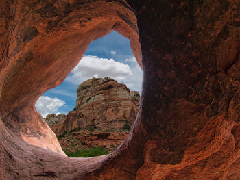 View of rock formation against cloudy sky