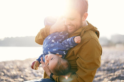 Father and son with baby