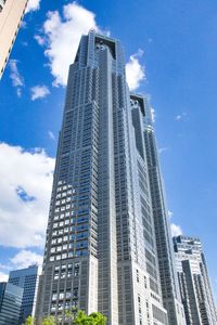 Low angle view of modern buildings against blue sky