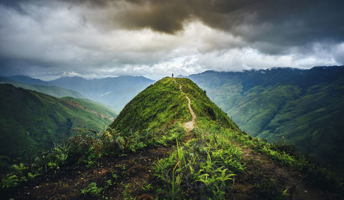 Scenic view of mountains against cloudy sky