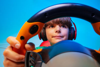 Cropped image of man holding steering wheel