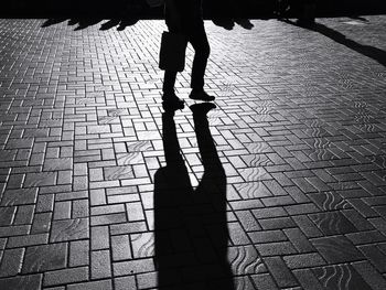 Low section of man walking on road