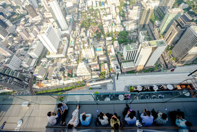 High angle view of people in city against buildings