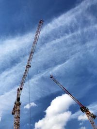 Low angle view of crane against sky