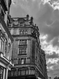 Low angle view of historic building against cloudy sky