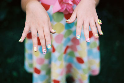 Close-up of hands holding multi colored hand