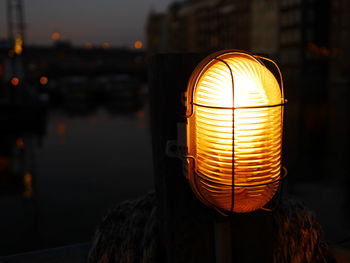 Close-up of illuminated electric lamp at night