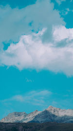 Low angle view of mountain against blue sky