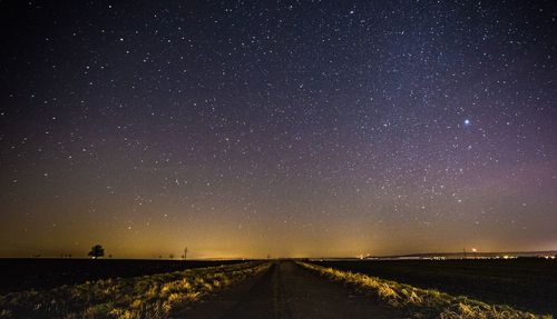 Road against sky at night