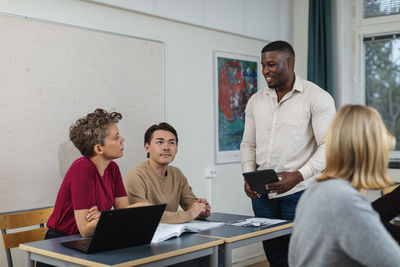 Male teacher helping student