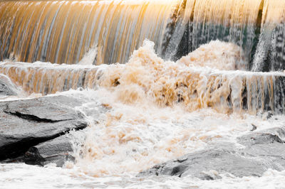 Water flowing through rocks in sea