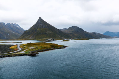 Empty road leading over the ocean with mountains in moskenesoya lofoten islands in norway