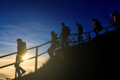 Low angle view of silhouette people against sky during sunset