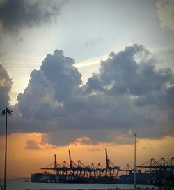 View of harbor against cloudy sky