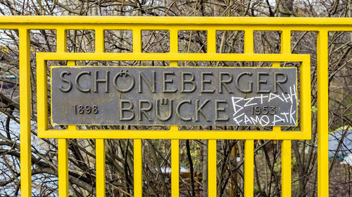 Close-up of yellow text on metal