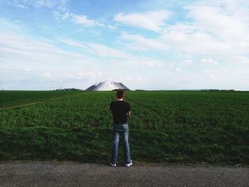 Rear view of man standing on roadside