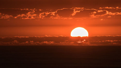 Scenic view of sea against romantic sky at sunset