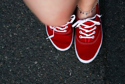 Low section of person wearing red shoe