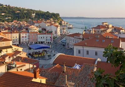 High angle view of townscape by sea against sky