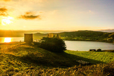 Scenic view of lake at sunset