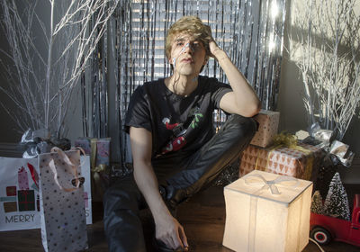 Portrait of young woman standing by window