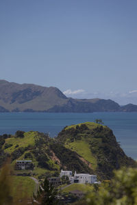 Scenic view of town by sea