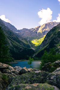 Scenic view of river amidst mountains against sky