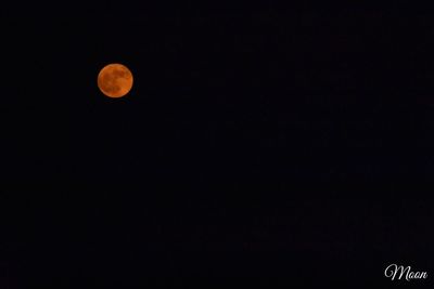 Low angle view of moon against clear sky at night