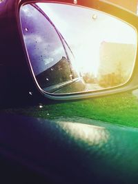 Reflection of clouds in side-view mirror