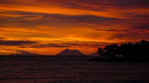 Scenic view of sea against orange sky