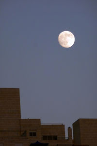 Low angle view of moon against clear sky at night