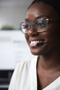 Smiling young woman working in call center