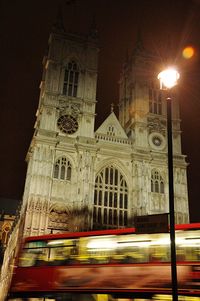 Low angle view of illuminated cathedral against sky at night