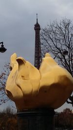 Statue of building against cloudy sky